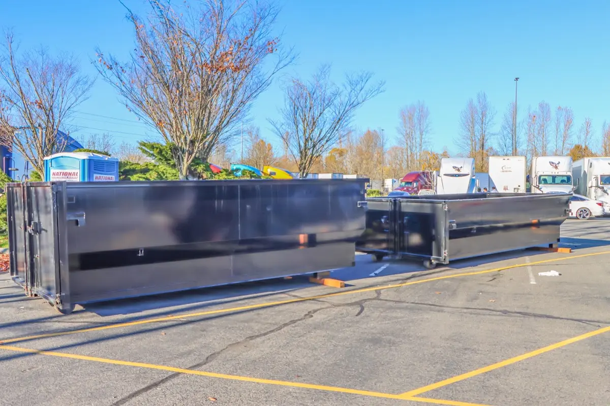 Professional dumpster rental service with roll-off container on residential driveway in Odenville